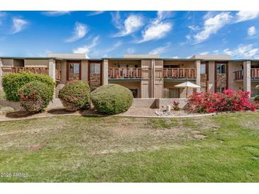 Inviting two-story condo with manicured landscaping, multiple balconies, and a neutral color palette at 4354 N 82Nd St # 178, Scottsdale, AZ 85251