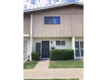 Exterior shot of home entrance featuring secure front door, trimmed bushes and a small, manicured lawn at 5425 N Black Cyn Hwy, Phoenix, AZ 85015