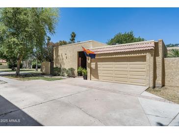 Charming home featuring a two-car garage, desert landscaping, and an Arizona flag at 6222 N 21St Dr, Phoenix, AZ 85015