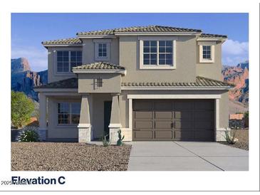 Two-story home with neutral color palette, tile roof, desert landscaping, and an attached two-car garage at 7404 W Buckhorn Trl, Peoria, AZ 85383