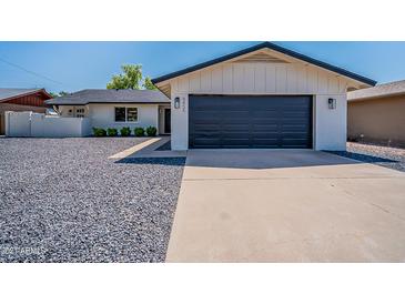 Charming single-Gathering home featuring a modern design, two-car garage, and low-maintenance landscaping at 8455 E Orange Blossom Ln, Scottsdale, AZ 85250