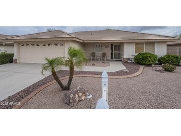 Charming single-story home featuring a well-manicured front yard and a two-car garage at 11012 E Knowles Ave, Mesa, AZ 85209