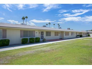 Charming one-story condo with well-maintained lawn and desert landscaping at 13632 N Silverbell Dr, Sun City, AZ 85351