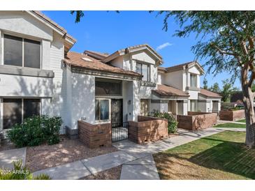Charming townhome with a well-maintained yard, inviting entrance, and classic desert landscaping at 2201 N Comanche Dr # 1094, Chandler, AZ 85224