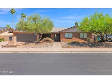 Lovely single-story brick home featuring desert landscaping and a two-car garage at 2524 E Elmwood St, Mesa, AZ 85213