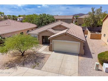 Charming single-story home with a well-maintained front yard and two-car garage at 2745 W Sunshine Butte Dr, San Tan Valley, AZ 85144