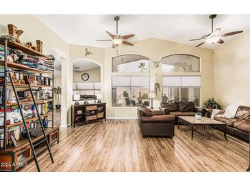 Bright living room with high ceilings, wood floors, and ample natural light at 29915 N Maravilla Dr, San Tan Valley, AZ 85143