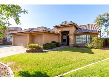 Charming home featuring a well-maintained front yard, tiled roof and a three-car garage at 3002 S Marigold Pl, Chandler, AZ 85248