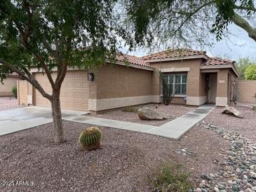 Charming single-story home features a well-kept front yard with desert landscaping and a two-car garage at 3212 W Lucia Dr, Phoenix, AZ 85083