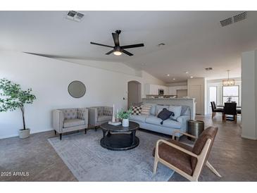Bright living room featuring modern furniture and a ceiling fan at 6432 S 23Rd Ave, Phoenix, AZ 85041