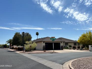 Charming single-story home featuring a two-car garage and desert landscaping at 9621 E Calgary Ave, Sun Lakes, AZ 85248