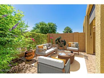 Comfortable outdoor patio featuring stylish seating, lush greenery, and a sunny ambiance for relaxation and entertainment at 1350 S Greenfield Rd # 1125, Mesa, AZ 85206