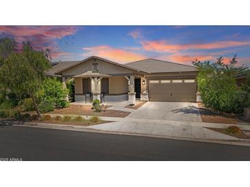 Beautiful single-Gathering home featuring a two-car garage and landscaped front yard, perfect for suburban living at 14634 W Wethersfield Rd, Surprise, AZ 85379