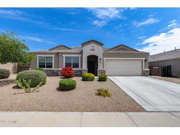 Charming single-story home with well-maintained landscaping and a two-car garage at 3515 N Brooklyn Dr, Buckeye, AZ 85396