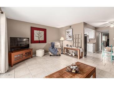 Inviting living room with neutral walls, tile floors, and decorative touches create a cozy atmosphere at 7436 E Chaparral Rd # 124B, Scottsdale, AZ 85250
