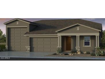 Charming single-story home with a three-car garage and covered front porch at 17812 W Luke Ave, Litchfield Park, AZ 85340