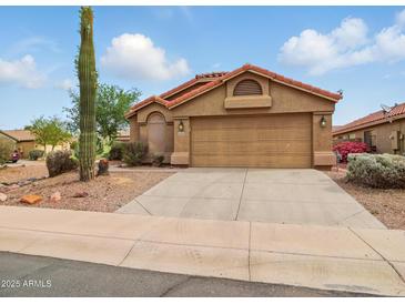 Charming single-Gathering home featuring a two-car garage and desert landscaping with a beautiful Saguaro cactus at 44010 W Wade Dr, Maricopa, AZ 85138