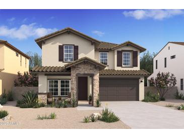Charming two-story home featuring stone accents and a covered entryway, enhancing curb appeal at 7420 S 76Th Ln, Laveen, AZ 85339