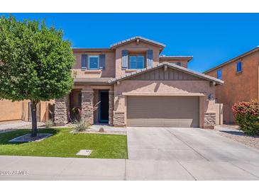 Charming two-story home featuring a well-manicured lawn and a spacious two-car garage at 900 E Harrison St, Chandler, AZ 85225