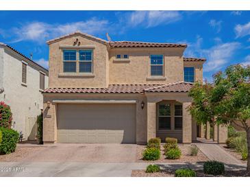 Charming two-story home with a tile roof, manicured landscaping, and an attached two-car garage at 9764 E Radioactive Dr, Mesa, AZ 85212