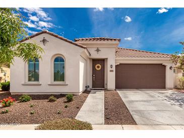 Charming single-story home with a well-manicured front yard and a cozy, inviting entryway at 14549 W Corrine Dr, Surprise, AZ 85379