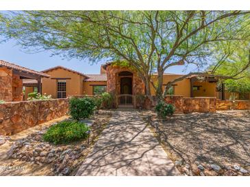 Stunning home featuring a secure gate, stone accents, and a well maintained desert landscape at 14619 E Desert Vista Trl, Scottsdale, AZ 85262