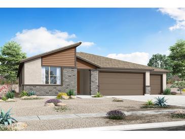 A charming single-story home featuring a three-car garage and a beautifully landscaped front yard with desert plants at 18462 W Mohave St, Goodyear, AZ 85338
