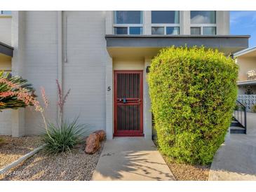 Charming front entrance with a secure screen door and decorative landscaping at 7319 E Northland Dr # 5, Scottsdale, AZ 85251