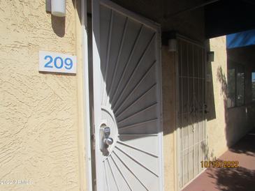 Apartment 209 shows a stylish security door entrance with a convenient electronic lock at 12221 W Bell Rd # 209, Surprise, AZ 85378