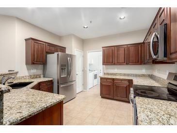 Well-lit kitchen featuring stainless steel appliances and granite countertops at 7516 S 31St Pl, Phoenix, AZ 85042