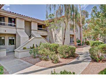 Charming condo featuring well-maintained landscaping, a private balcony, and beautiful Southwestern architecture at 9450 N 94Th Pl # 214, Scottsdale, AZ 85258