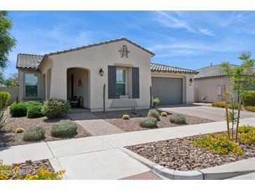 Charming home with desert landscaping, covered entry, and attached two-car garage at 10631 E Tallahassee Ave, Mesa, AZ 85212