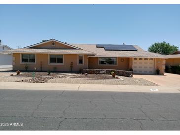 Charming, single story home with a 2-car garage, desert landscaping, and solar panels at 11415 N 110Th Dr, Sun City, AZ 85351