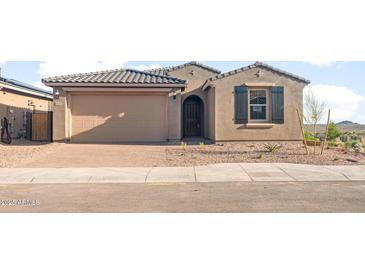 Charming single-story home featuring a two-car garage, neutral stucco, and low-maintenance desert landscaping at 13551 W Calle De Baca --, Peoria, AZ 85383