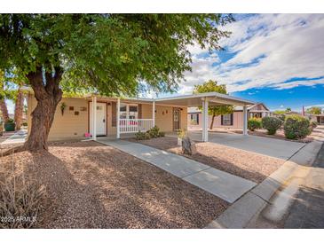 Inviting home exterior featuring covered parking, desert landscaping, and a charming front porch at 155 E Rodeo Rd # 64, Casa Grande, AZ 85122