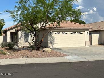 Charming single-story home with a well-maintained front yard and a two-car garage at 20275 N 81St Ln, Peoria, AZ 85382