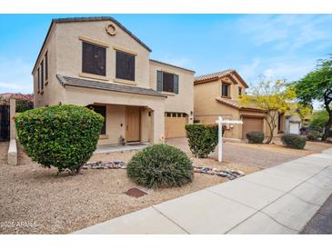 Charming two-story home with beautiful landscaping and a warm, inviting facade at 2323 W Hunter Ct, Phoenix, AZ 85085