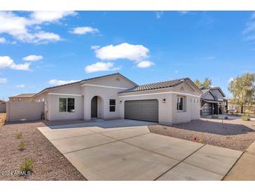 Beautiful single-story home featuring a well-maintained yard and a two-car garage at 2512 N Pony Ln, Casa Grande, AZ 85122