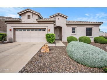 Charming single-story home featuring a well-manicured front yard and a two car garage at 4960 E Villa Theresa Dr, Scottsdale, AZ 85254