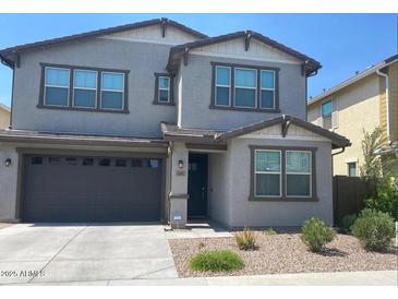 Charming two-story home with a well-maintained front yard and attached two-car garage at 1081 E Armstrong Way, Chandler, AZ 85286