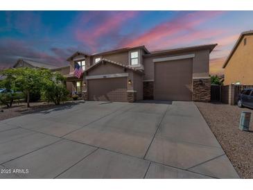 Beautiful two-story home with a three-car garage and well-manicured front yard at 12238 W Patrick Ct, Sun City, AZ 85373