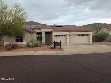 Attractive single-Gathering home with a three-car garage and desert landscaping at 20677 N 16Th Way, Phoenix, AZ 85024