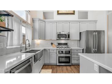 Well-appointed kitchen featuring stainless appliances, stylish countertops, and ample cabinet space for storage at 3521 N Barron --, Mesa, AZ 85207