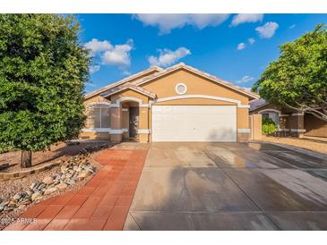 Charming single-story home with a two-car garage, desert landscaping, and a welcoming facade at 425 S 93Rd Pl, Mesa, AZ 85208