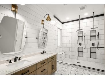 This bathroom features a double vanity and a large shower with dual shower heads at 4512 W Rushmore Dr, Anthem, AZ 85087