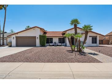 Charming single-story home featuring desert landscaping, a tile roof, and inviting curb appeal at 5415 E Juniper Ave, Scottsdale, AZ 85254