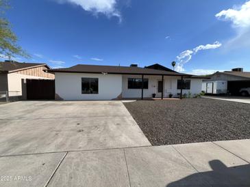Charming single-story home with well-maintained gravel landscaping and wide driveway at 5539 W Wilshire Dr, Phoenix, AZ 85035