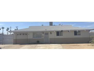 Charming single-story home featuring desert landscaping, an attached garage, and a white-tiled roof at 6226 W Citrus Way, Glendale, AZ 85301