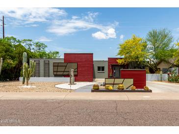 Unique home boasts drought-tolerant landscaping, red siding accents, and plenty of curb appeal at 8314 E Vista Dr, Scottsdale, AZ 85250
