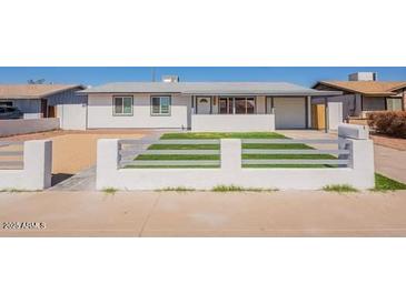 Charming single-story home featuring a well-maintained front yard and inviting curb appeal at 8802 W Monterey Way, Phoenix, AZ 85037